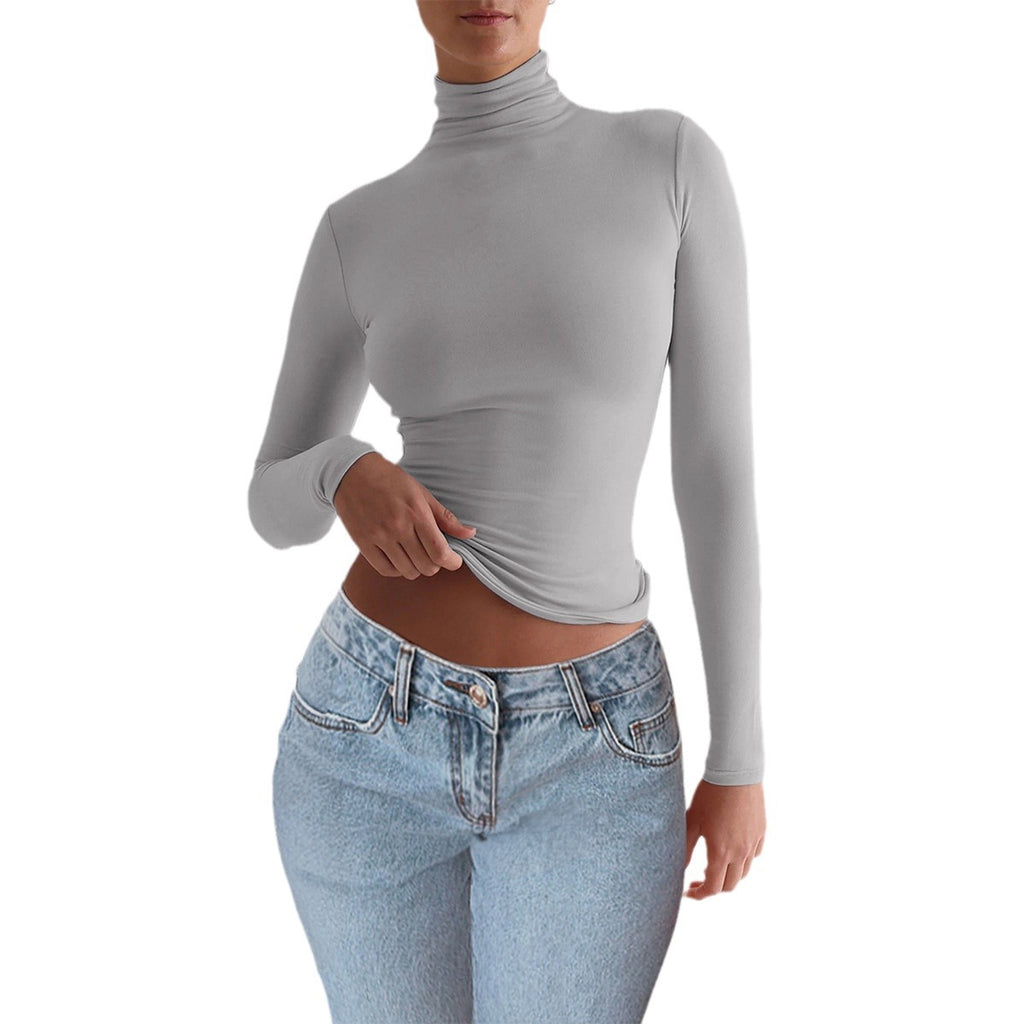 Adult model wearing the gray fitted long-sleeve turtleneck top, front view.