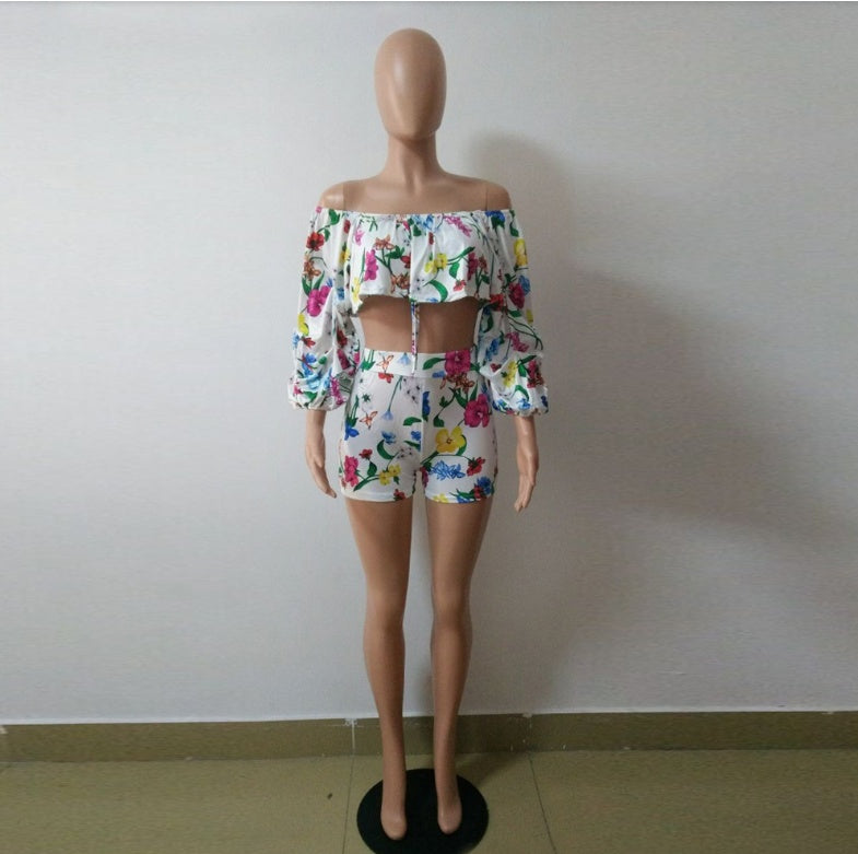 Adult model wearing the botanical-print long-sleeve ruffle top and high-waist shorts set.