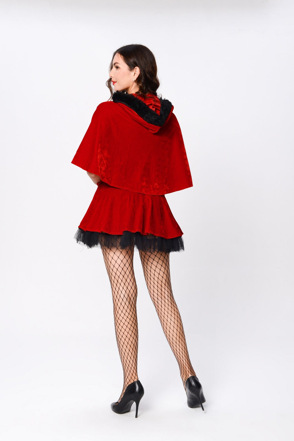 Adult model wearing the red cape and dress with black trim, back view.