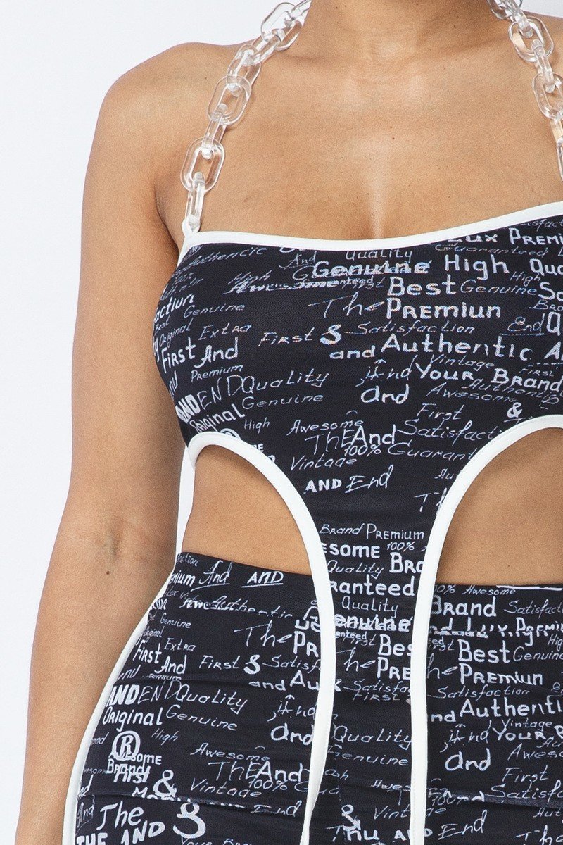 Close view of the clear plastic chain halter, straight neckline, white piping and curved crop-top cutouts