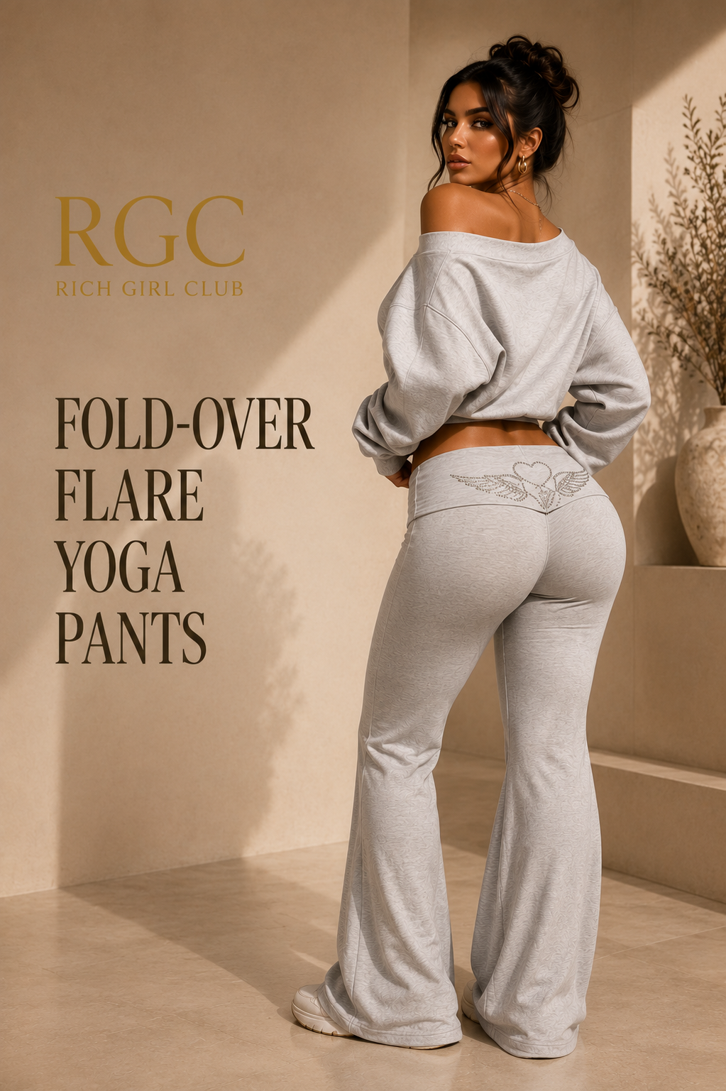 Rich Girl Club campaign image of an adult model wearing heather-gray fold-over flare yoga pants, showing the silver winged-heart back waistband detail