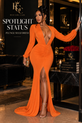 Spotlight Status Plunge Maxi Dress RGC campaign hero in orange, showing the long sleeves, plunging V neckline, gathered waist, and front slit.