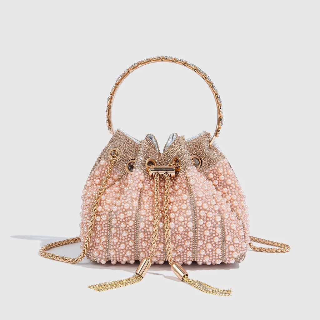 Main Character Rhinestone Clutch Pink design with pale pink pearl panels, rose-gold handle, drawstring, and chain strap