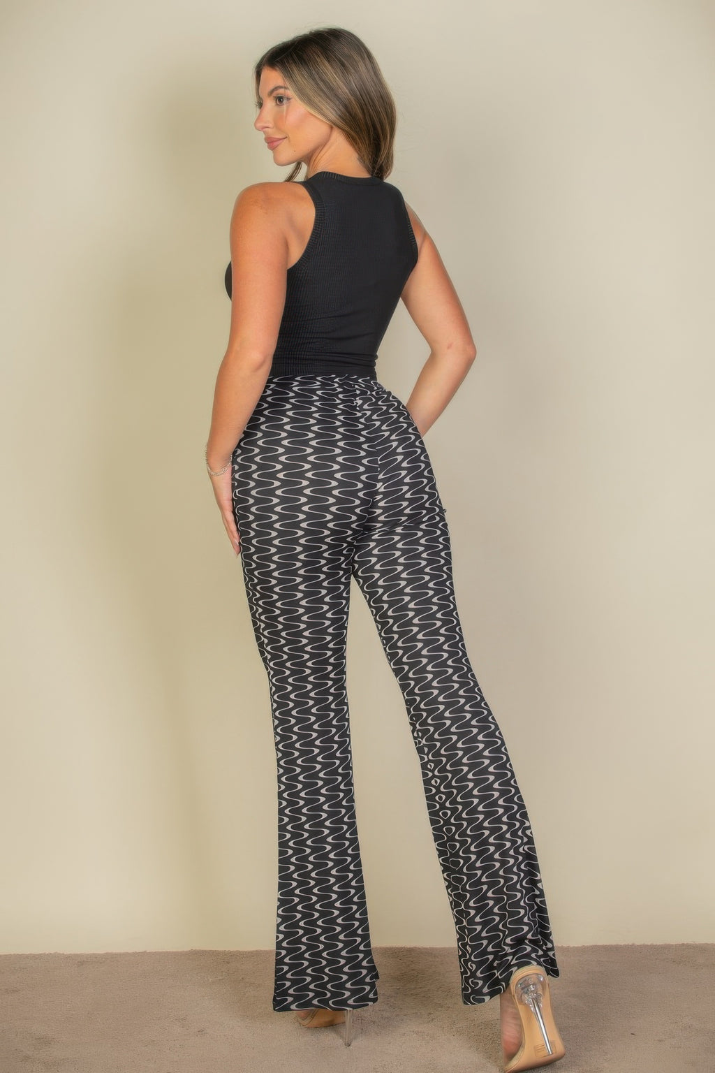 Rear view of the black Exclusive Edition Rib Tank Graphic Top showing the plain ribbed back and straight cropped hem