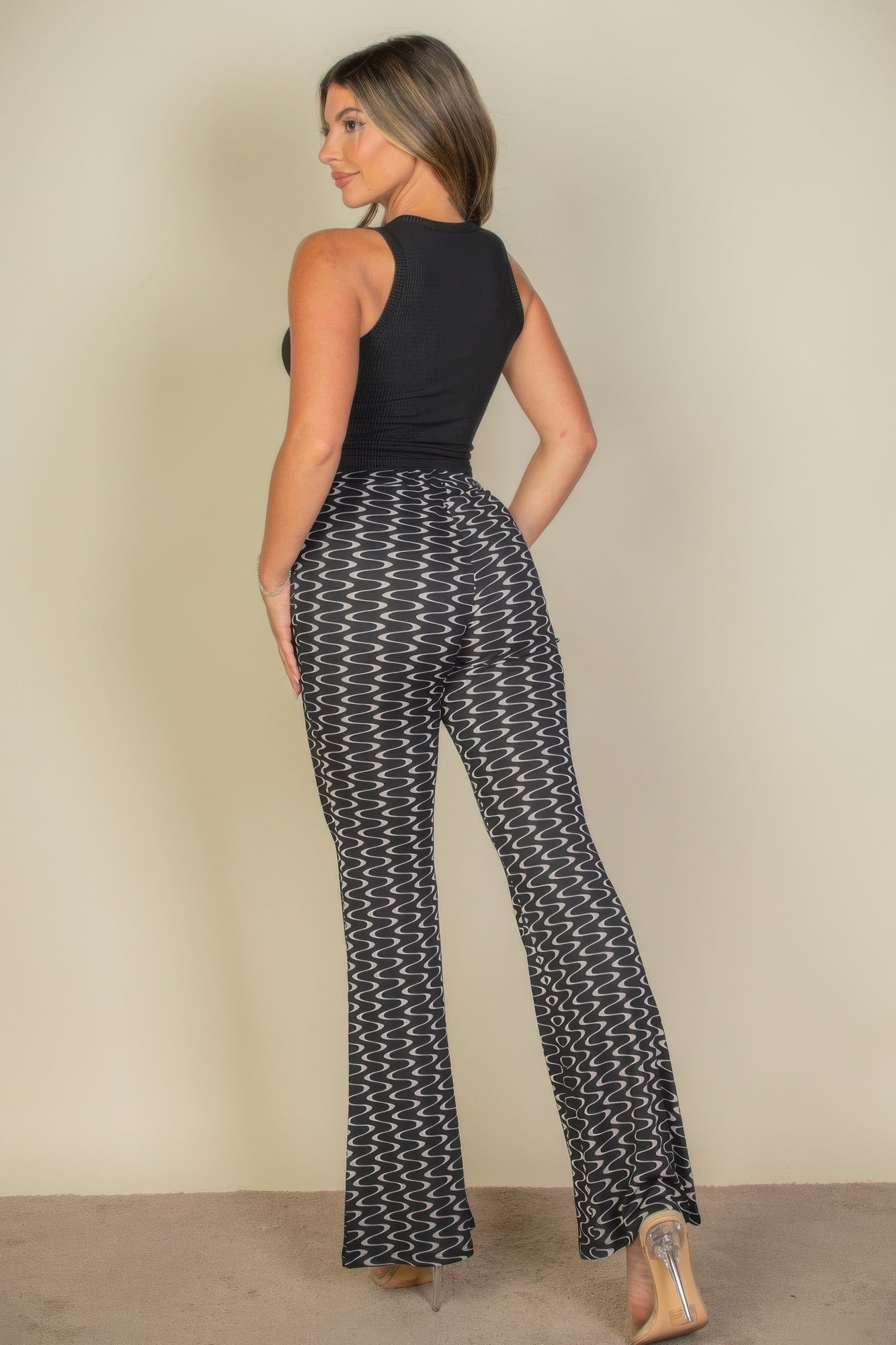 Rear view of the black Exclusive Edition Rib Tank Graphic Top showing the plain ribbed back and straight cropped hem