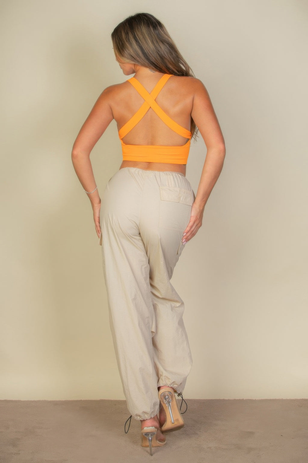 Soft Power Tangelo crop top showing crossed open-back straps