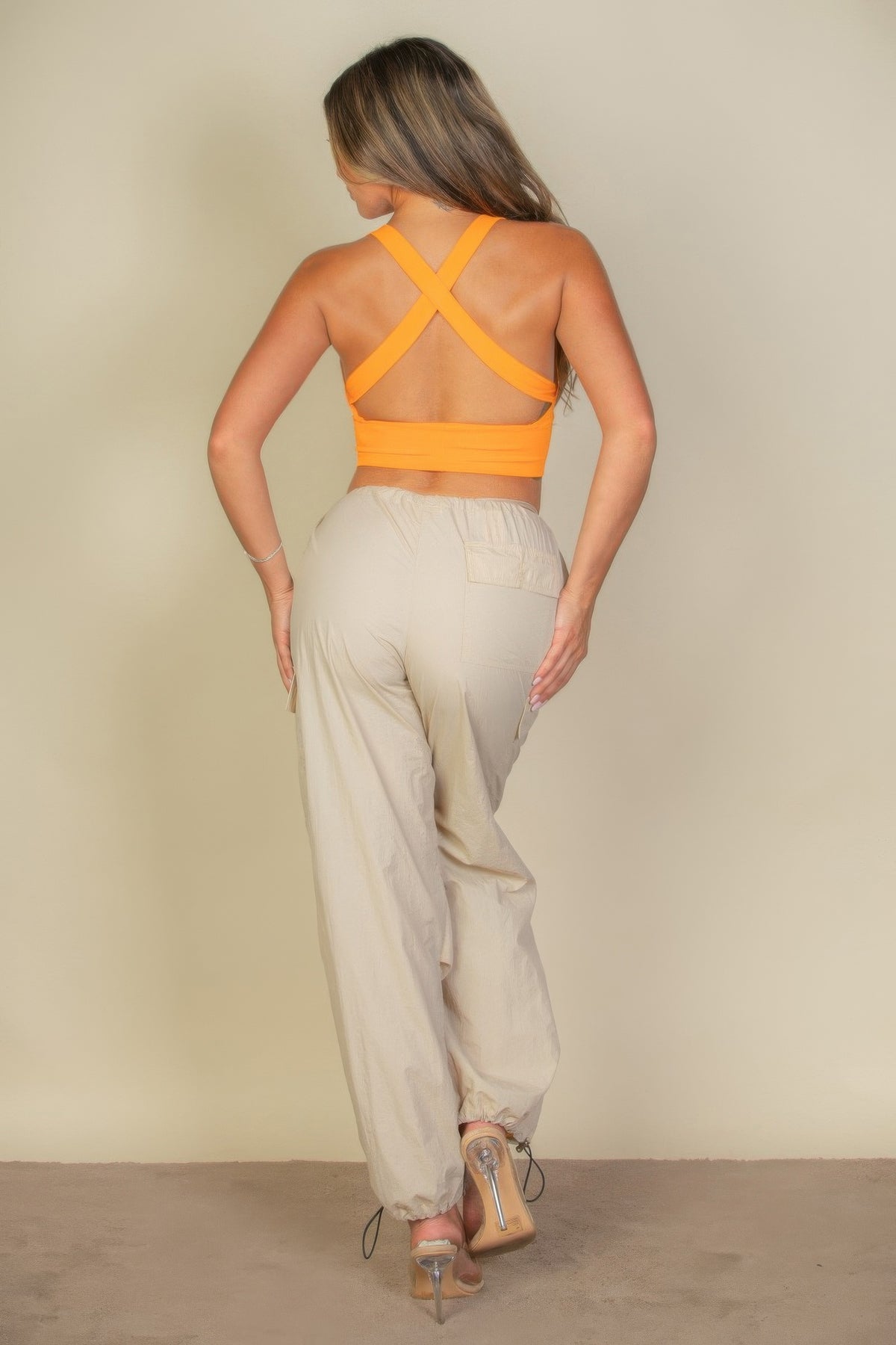 Soft Power Tangelo crop top showing crossed open-back straps