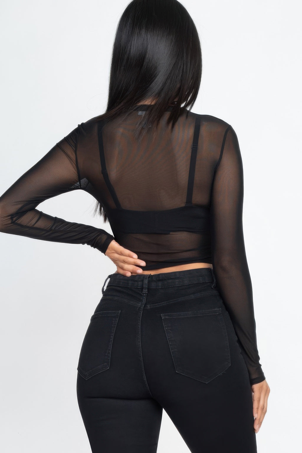 Back view of the black After Dark Sheer Mesh Crop Top showing the sheer long sleeves and straight cropped hem