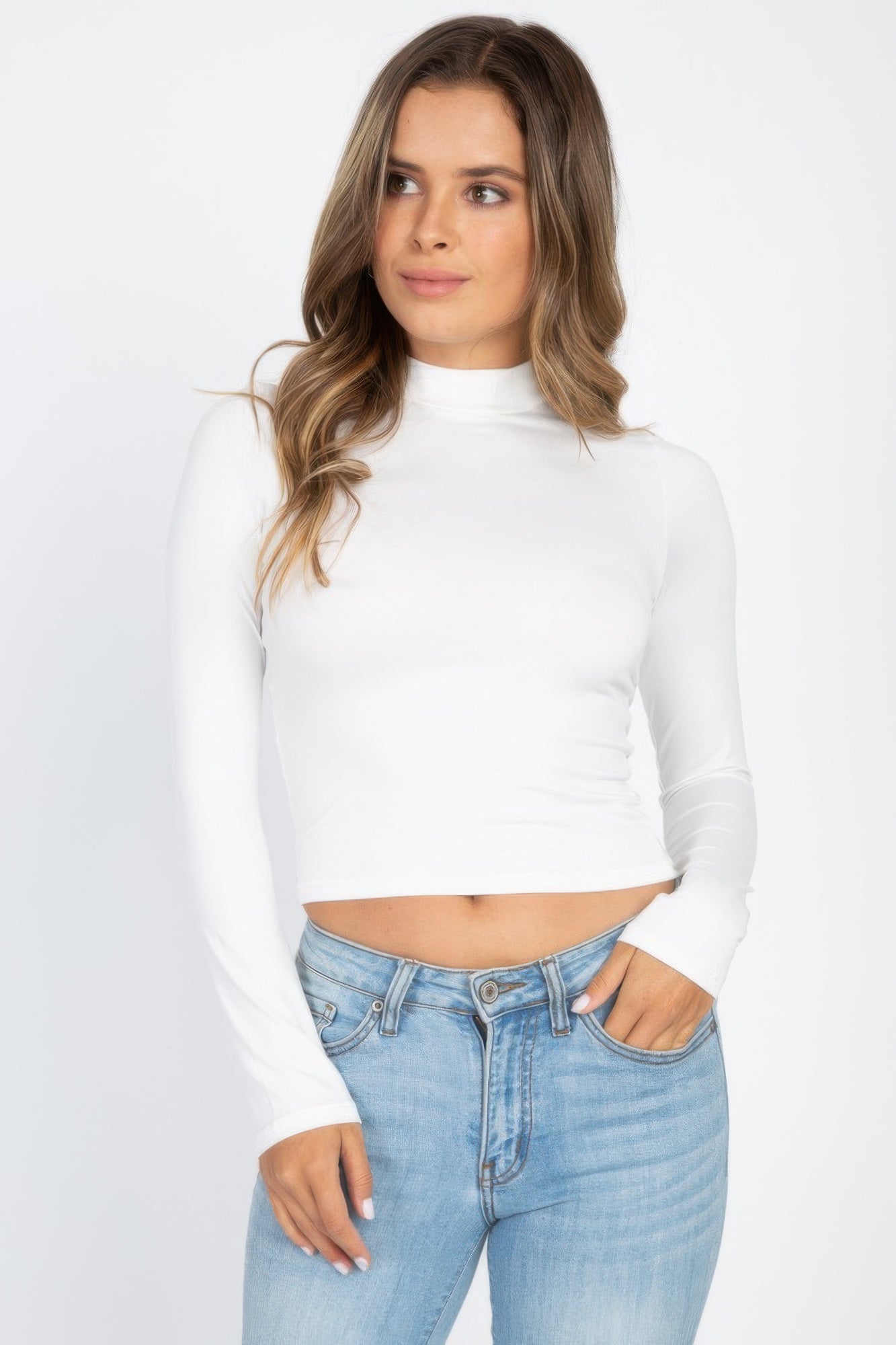 White Mock Neck Solid Long Sleeve Top shown from the front with light blue jeans
