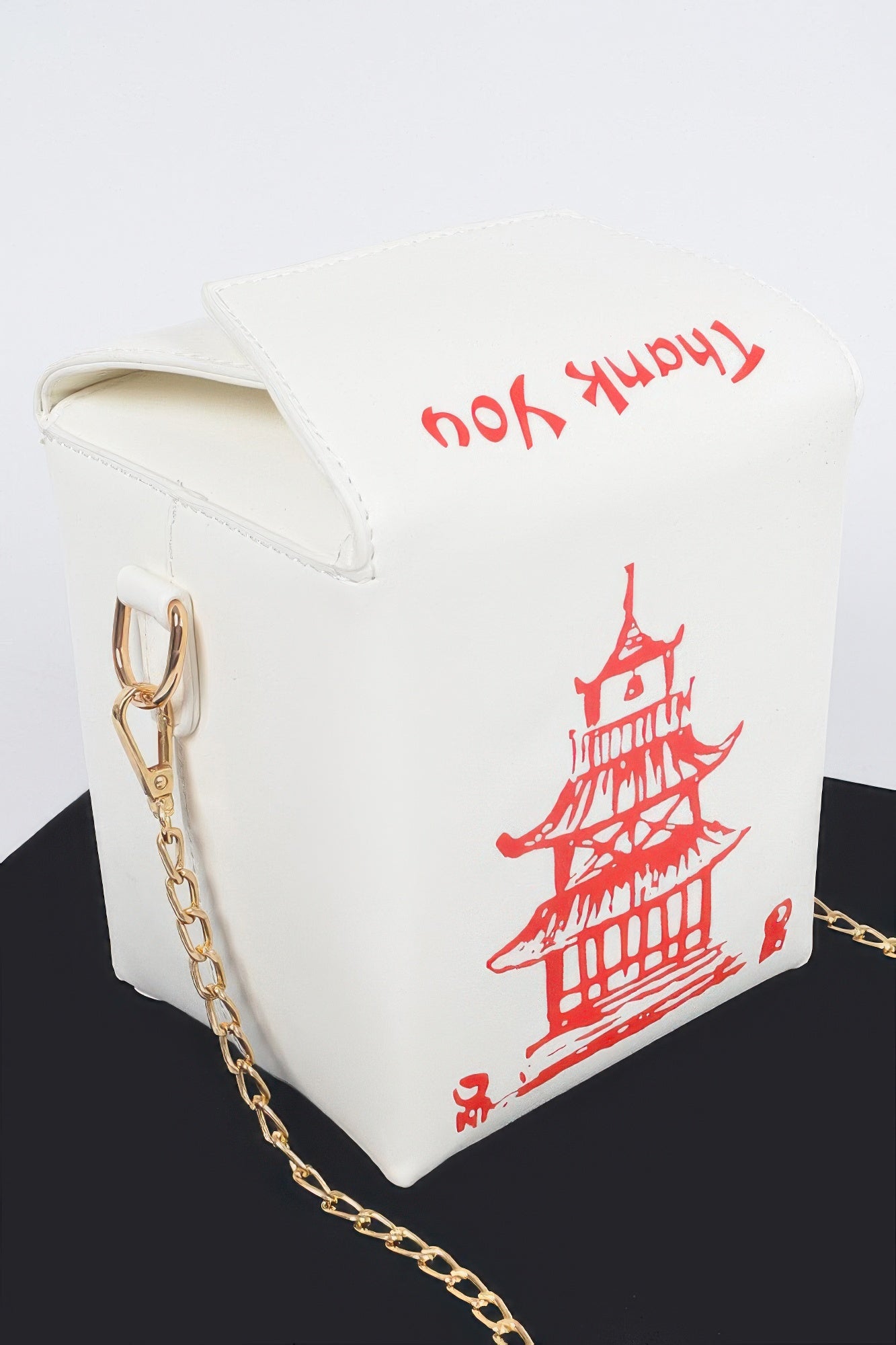 White Chinese To Go Box Clutch angled side view showing structured carton silhouette