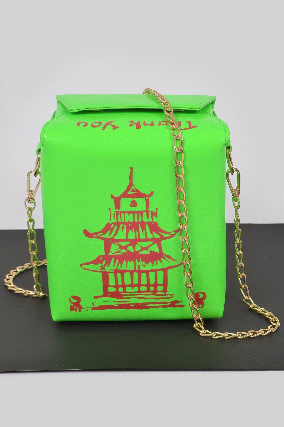 Neon green Chinese To Go Box Clutch front view with red pagoda graphic