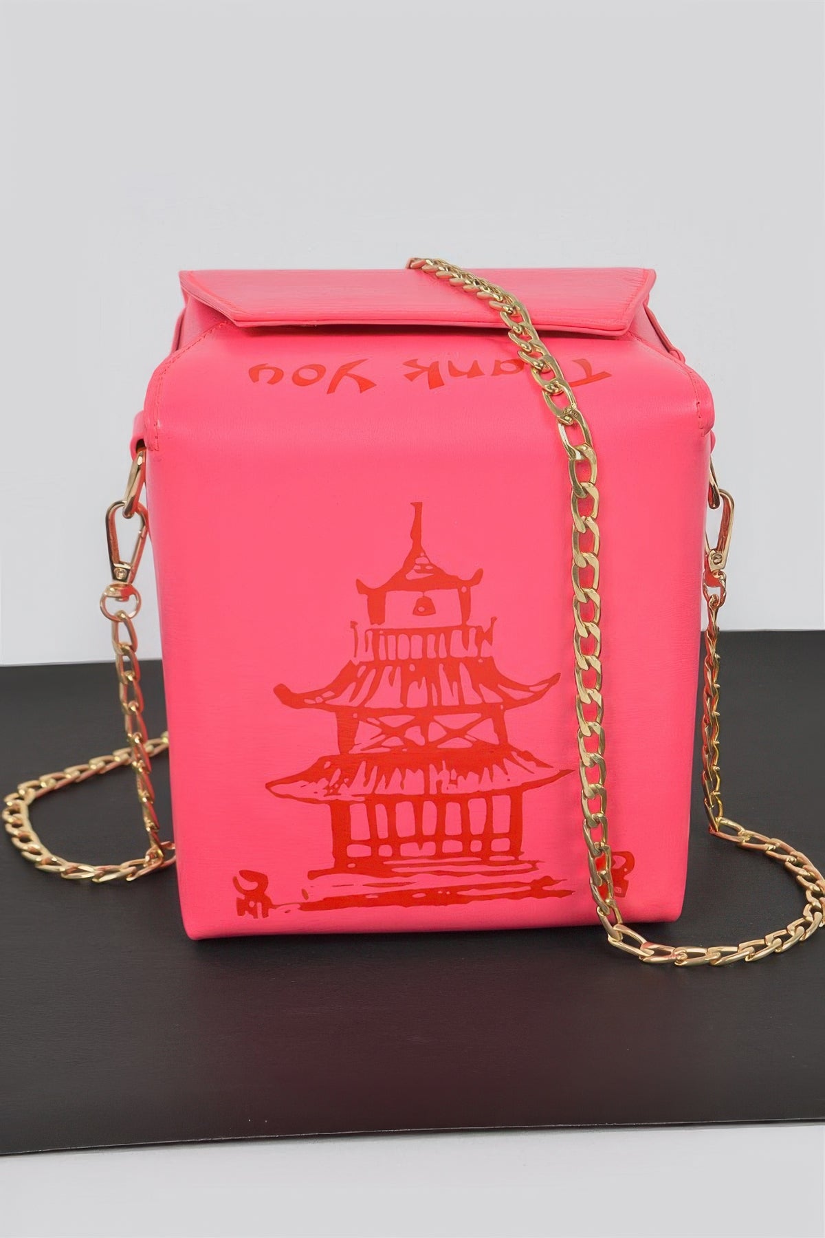 Neon pink Chinese To Go Box Clutch front view with red pagoda graphic