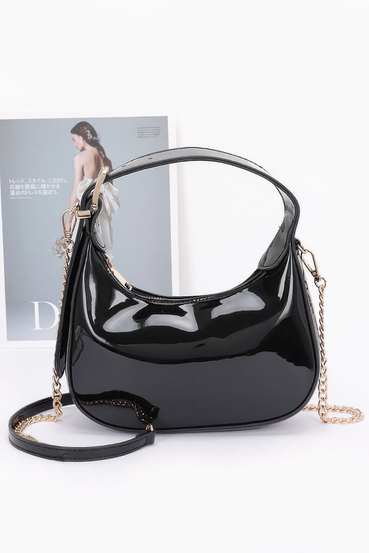 Black Enamel Hobo Bag with glossy finish, adjustable short handle and detachable gold-chain strap, front view