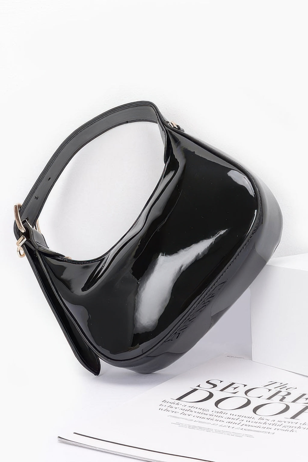 Black Enamel Hobo Bag rear and side view showing glossy hobo silhouette and adjustable handle