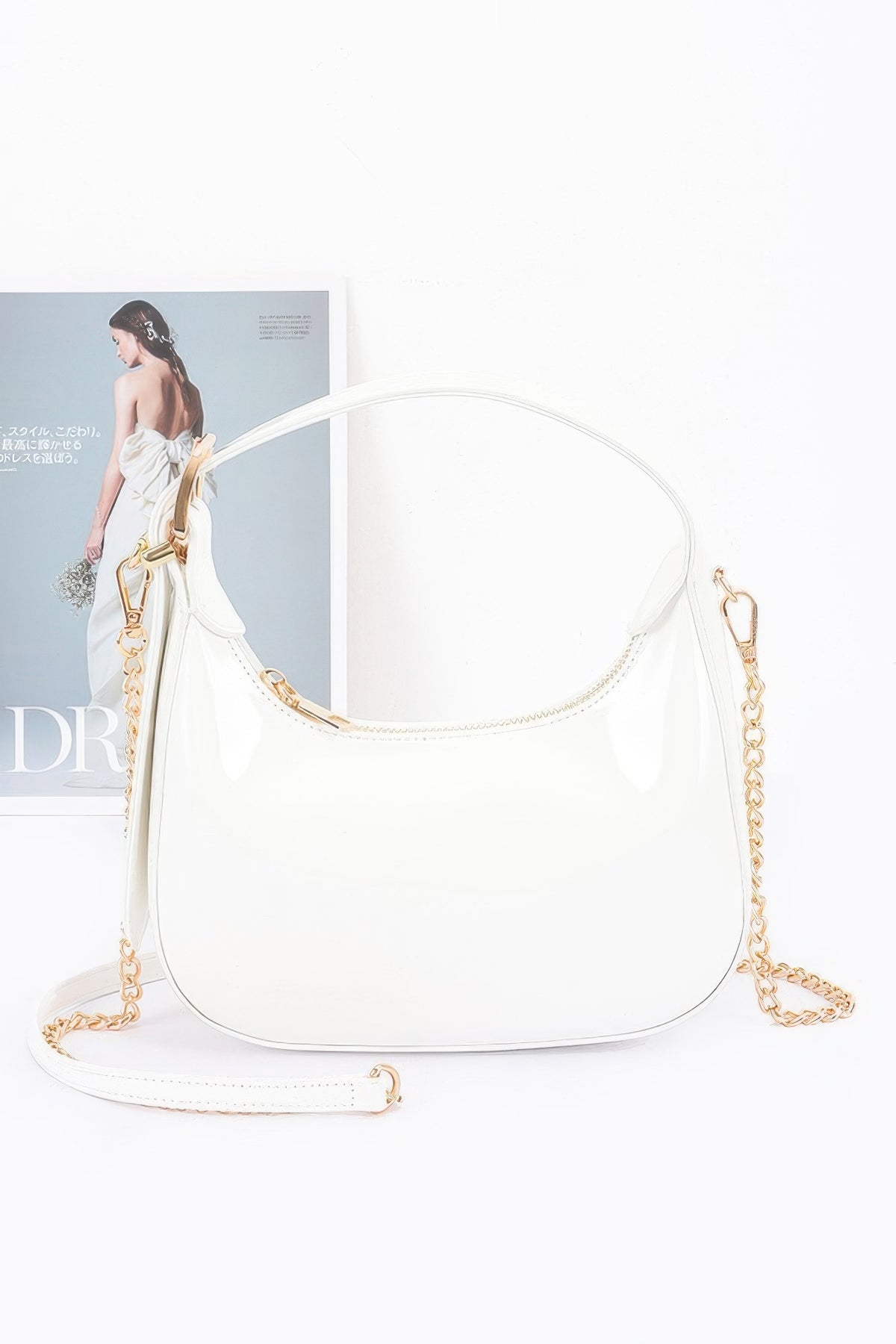 White Enamel Hobo Bag with glossy finish, short handle and detachable gold-chain strap, front view