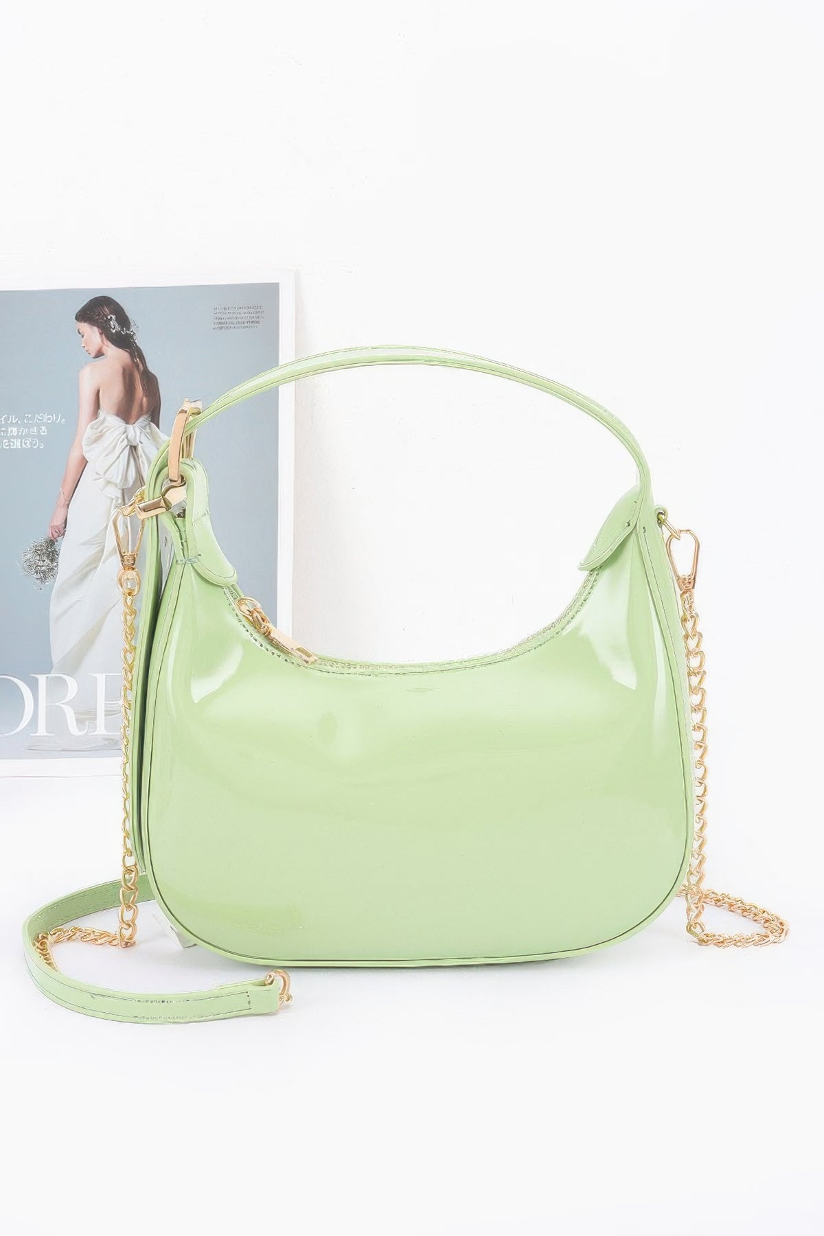 Light olive Enamel Hobo Bag with glossy finish, short handle and detachable gold-chain strap, front view