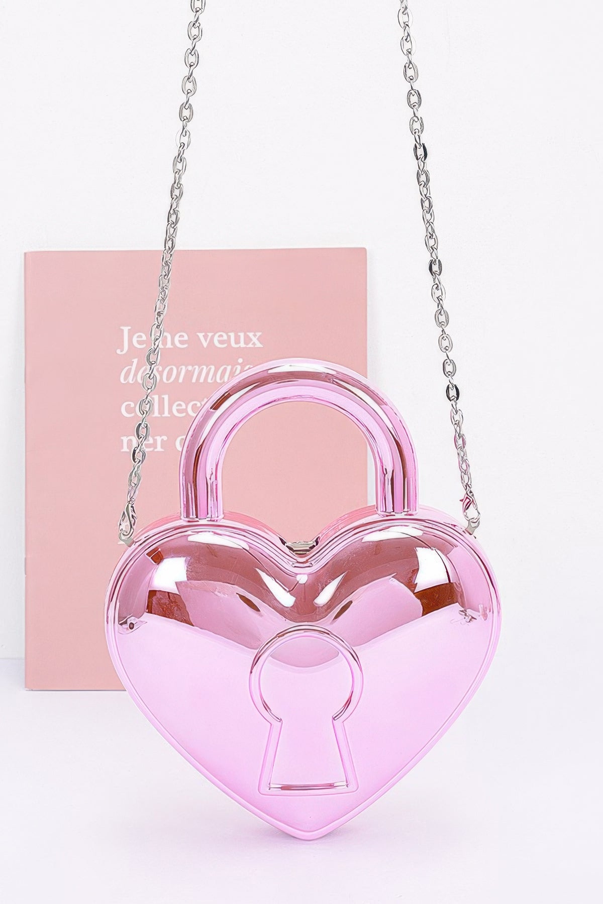 Fuchsia heart-shaped Metallic Acrylic Bag with rounded top handle, keyhole motif and silver-tone chain strap