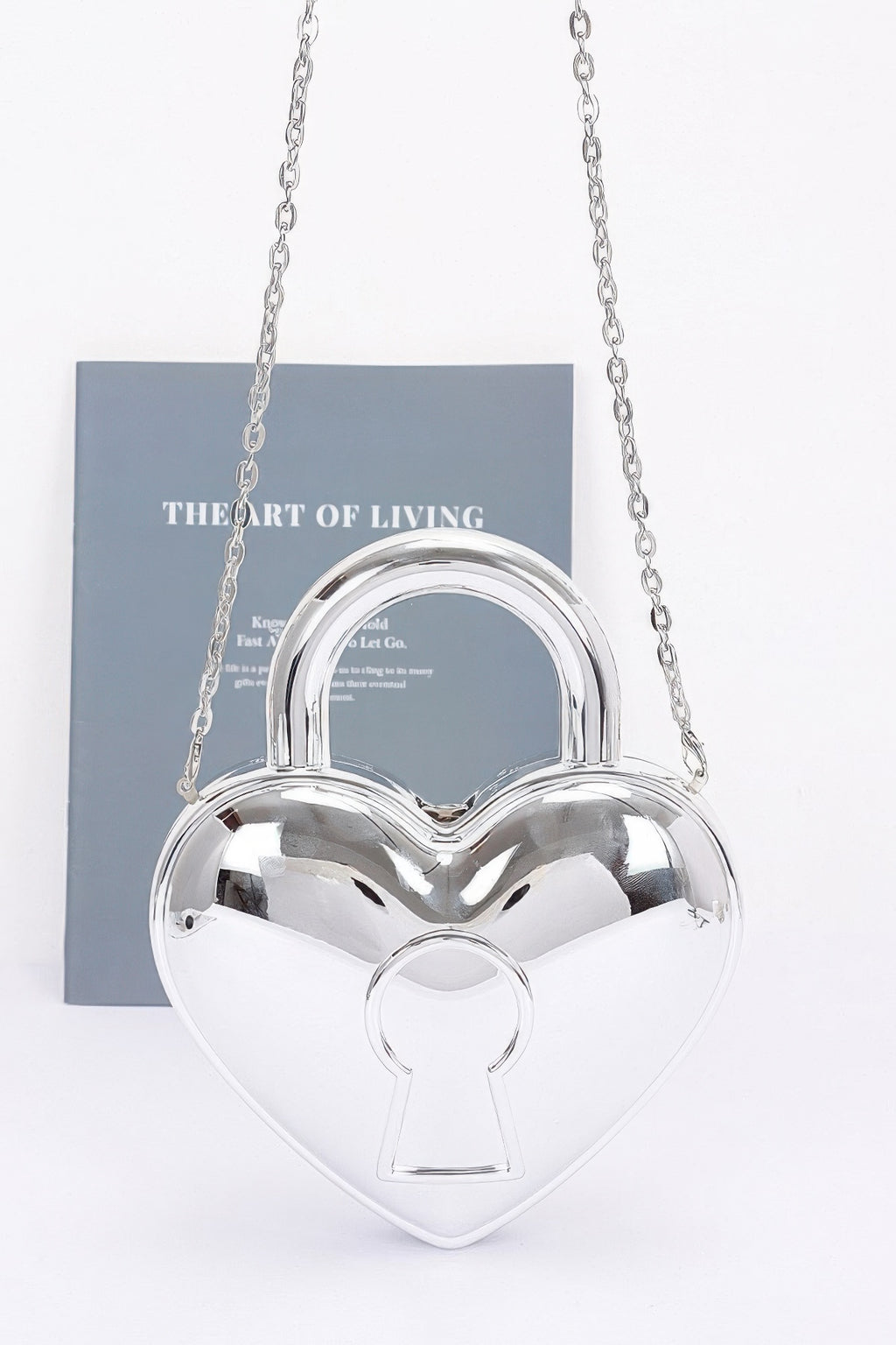 Silver heart-shaped Metallic Acrylic Bag with rounded top handle, keyhole motif and silver-tone chain strap