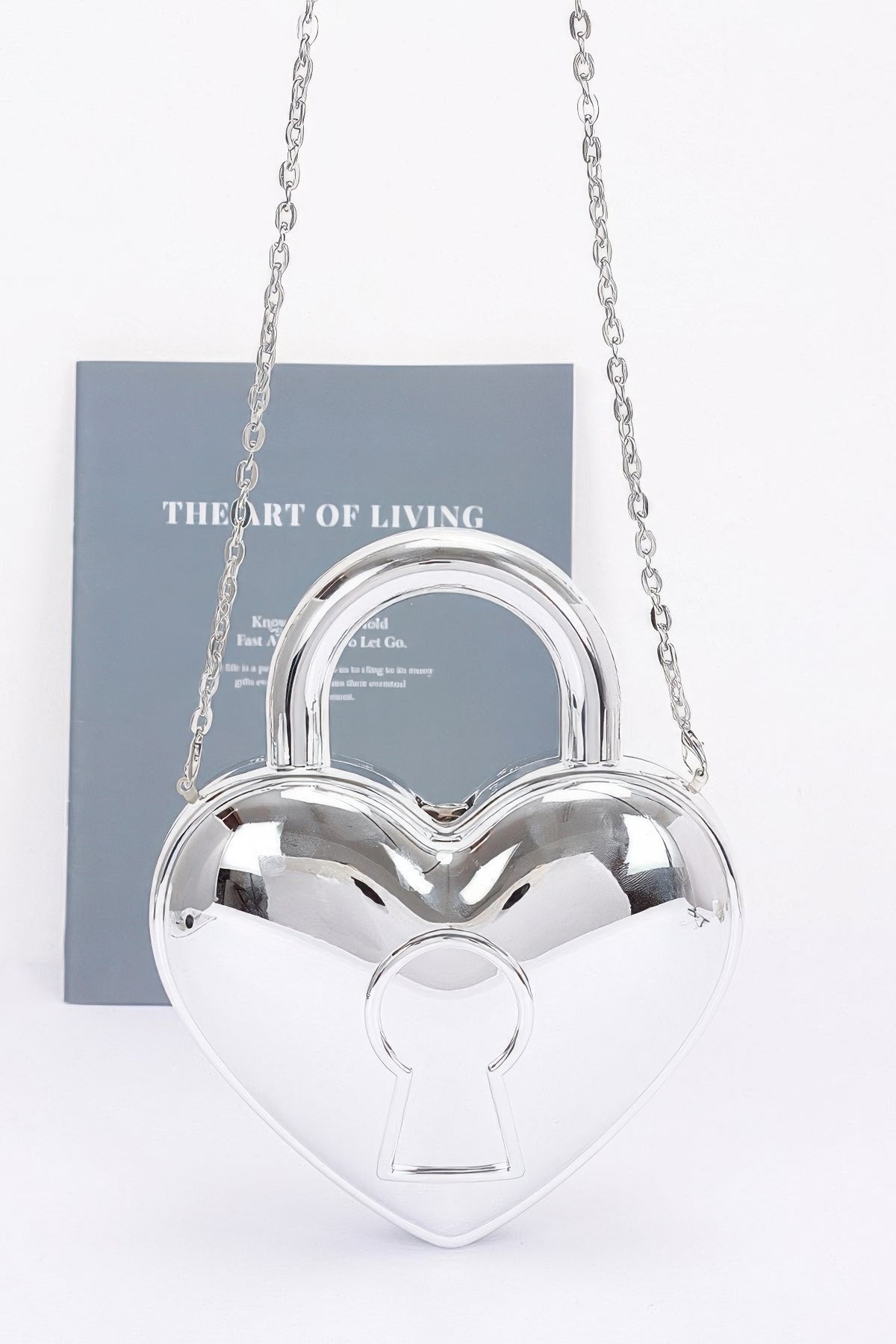 Silver heart-shaped Metallic Acrylic Bag with rounded top handle, keyhole motif and silver-tone chain strap