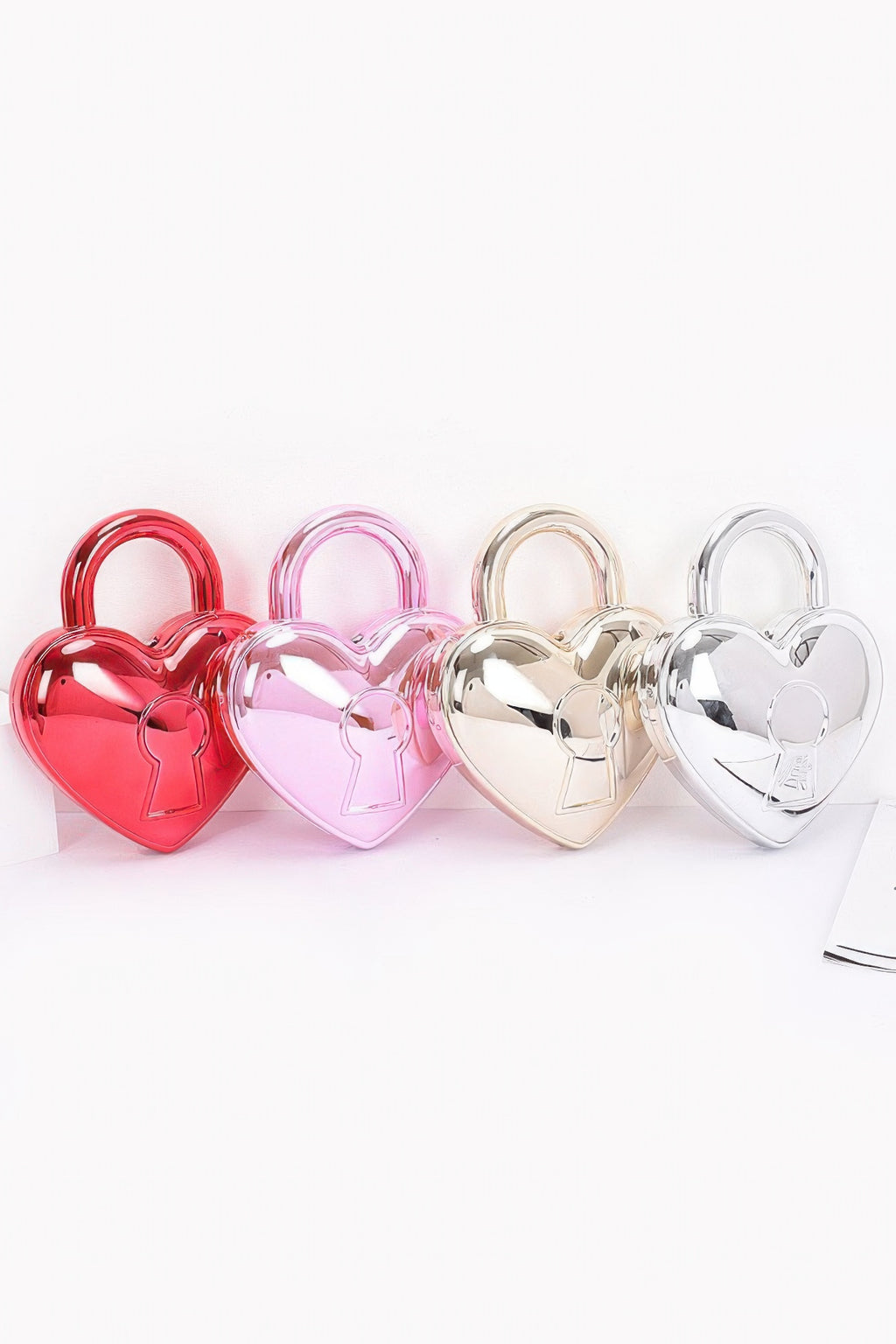 Metallic Acrylic Bag color lineup in red, fuchsia, gold and silver, front view