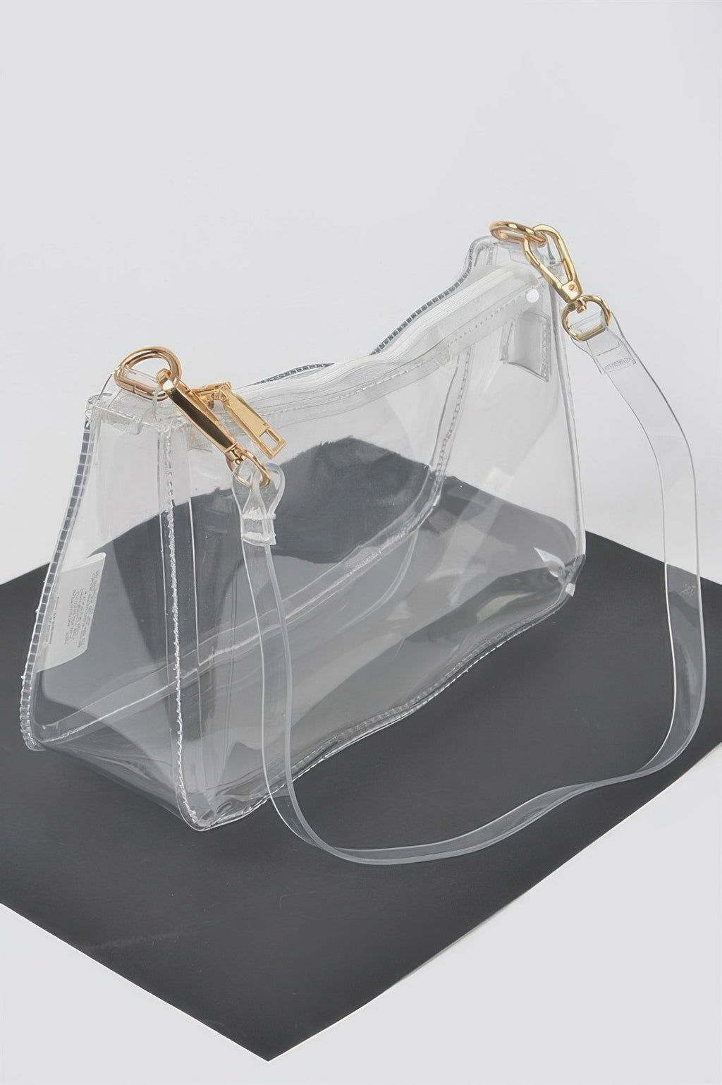 Clear Transparent Shoulder Bag, angled view showing the top zipper and gold clasps