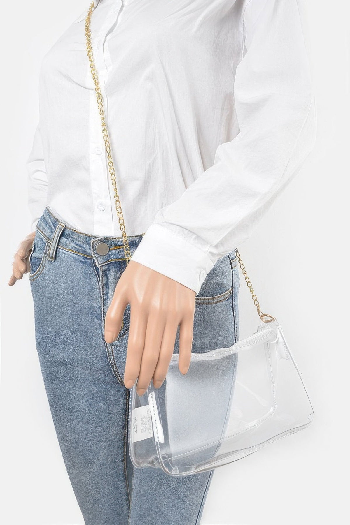 Model carrying the clear Transparent Shoulder Bag with the gold chain strap