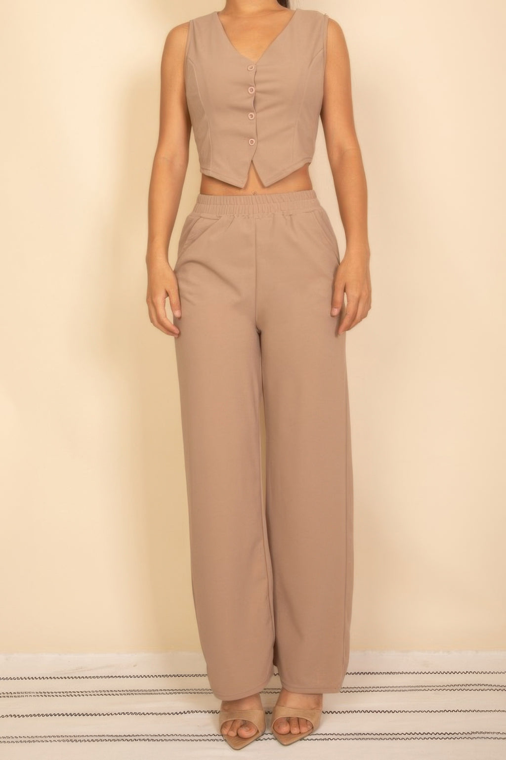 Taupe sleeveless four-button V-neck vest with matching elastic-waist wide-leg pants, full front view