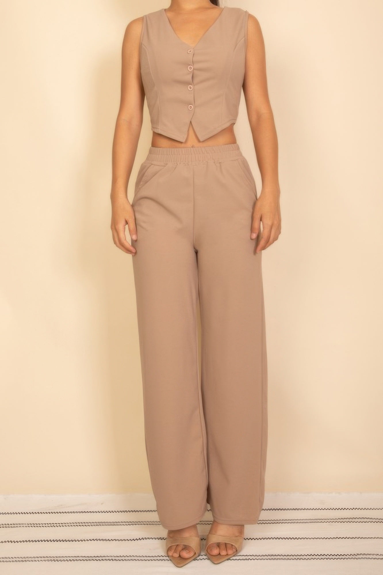 Taupe sleeveless four-button V-neck vest with matching elastic-waist wide-leg pants, full front view