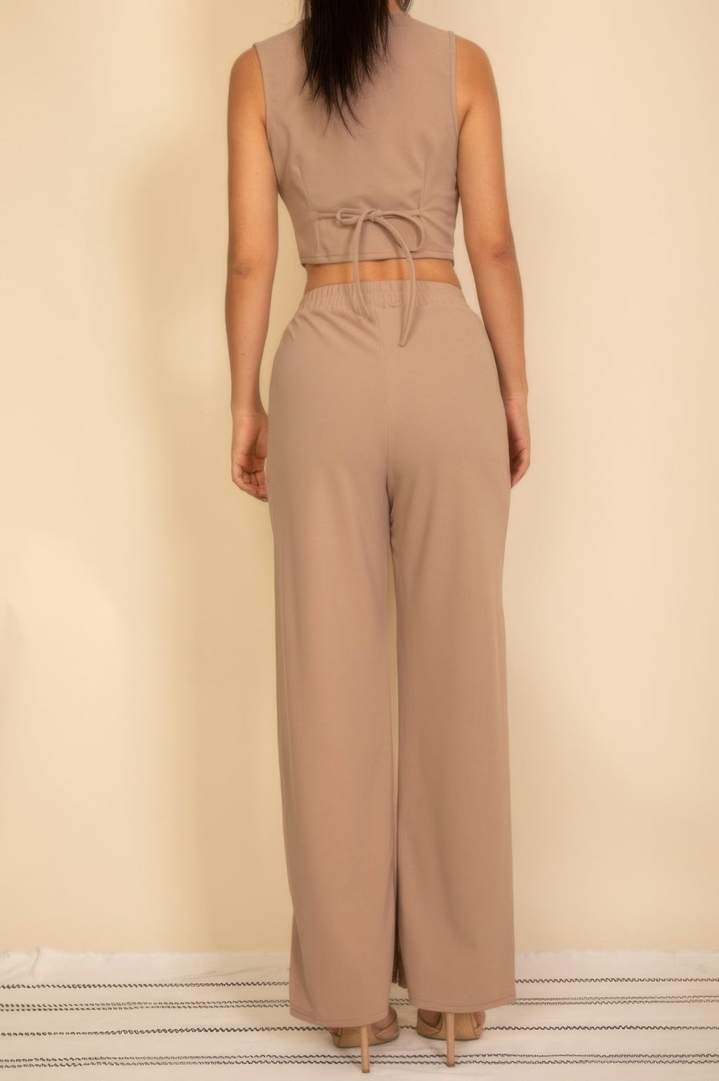 Taupe vest showing adjustable back waist tie with matching wide-leg pants, full rear view