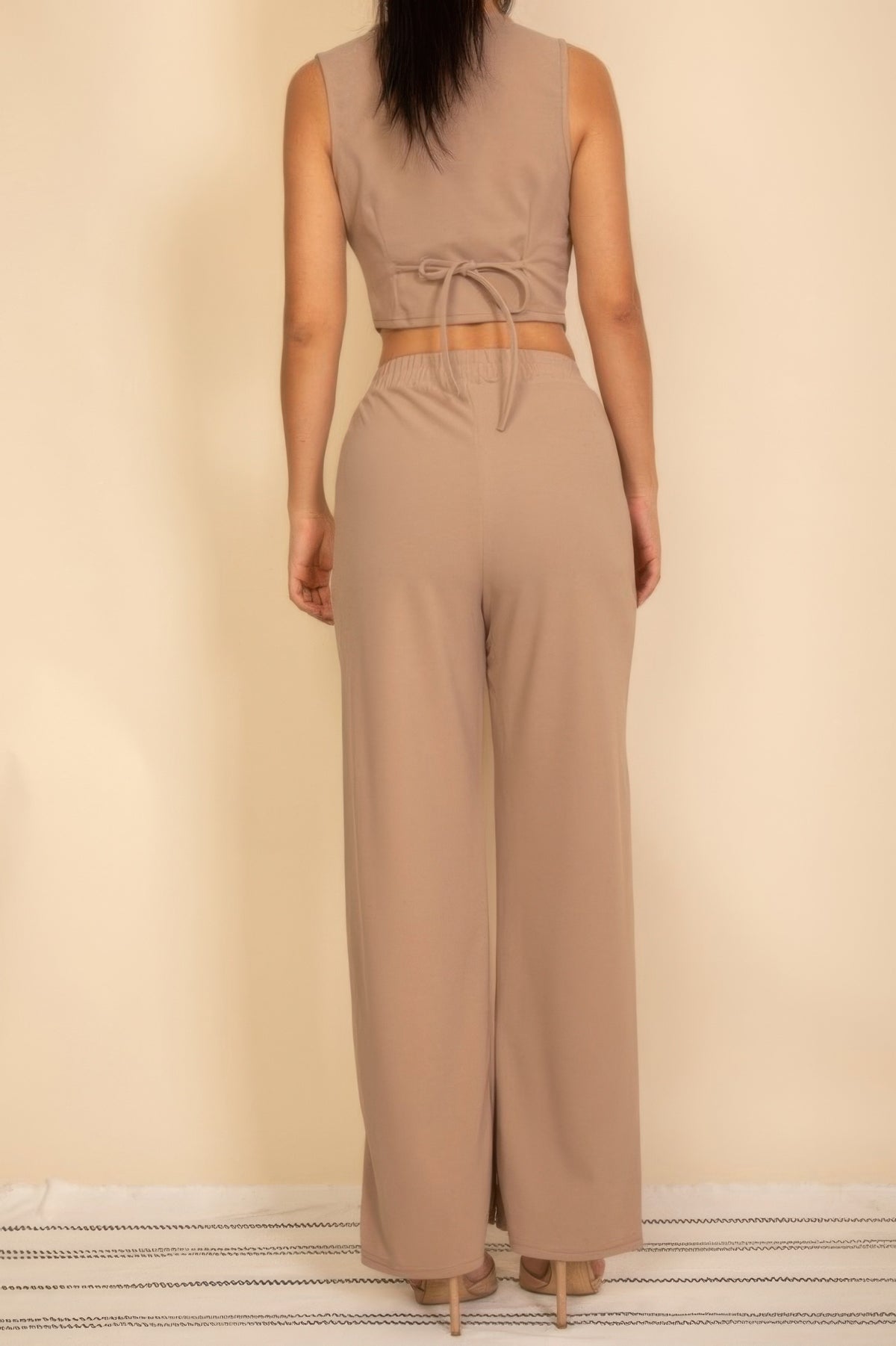 Taupe vest showing adjustable back waist tie with matching wide-leg pants, full rear view