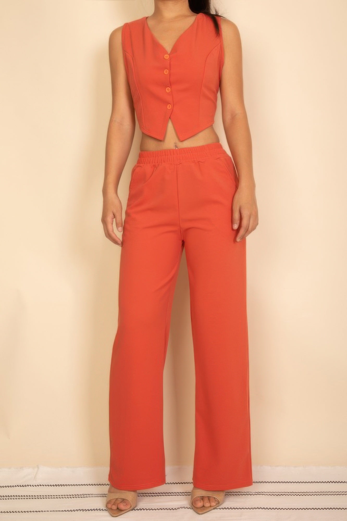 Rust sleeveless four-button V-neck vest and matching wide-leg pants, full front view