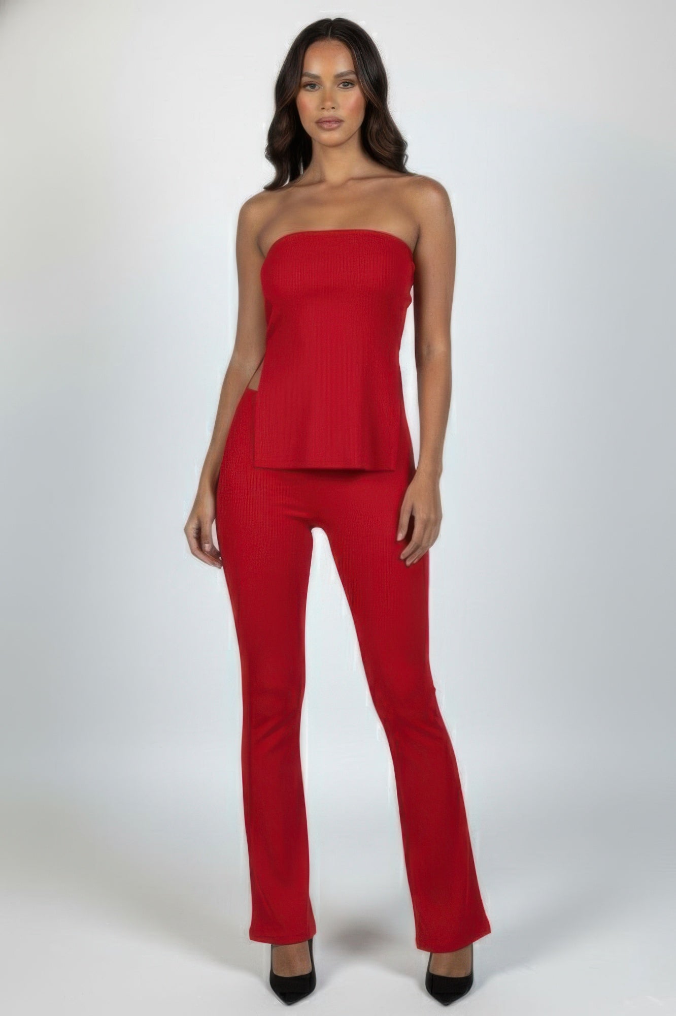 Front view of the rust strapless ribbed slit tube top and high-waist flare pants set