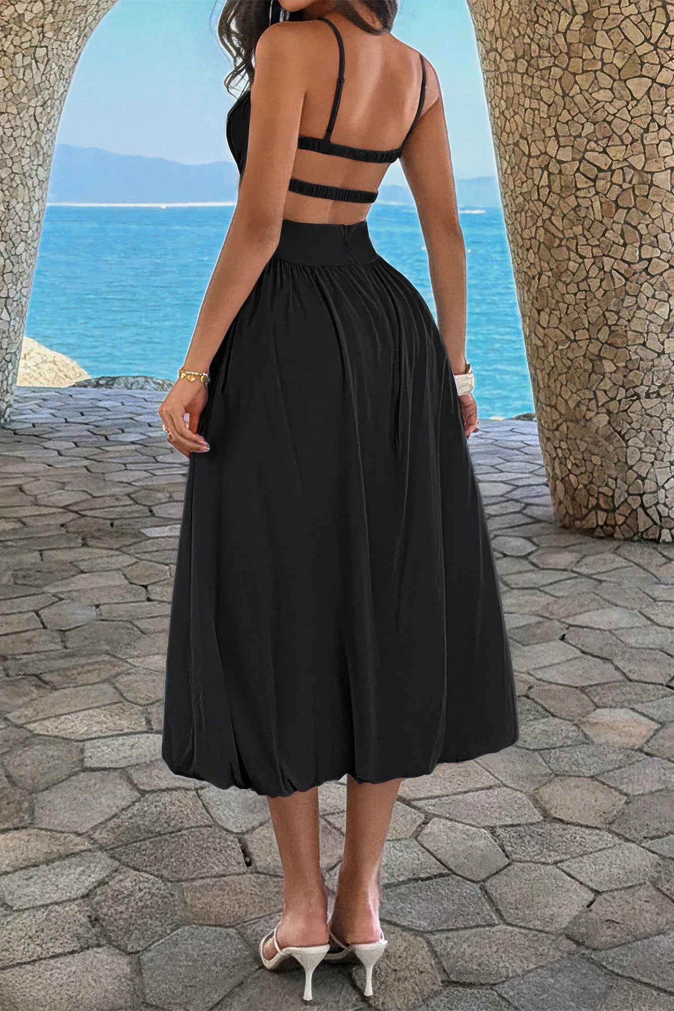 Back view of the black dress showing the open back and two horizontal elastic bands
