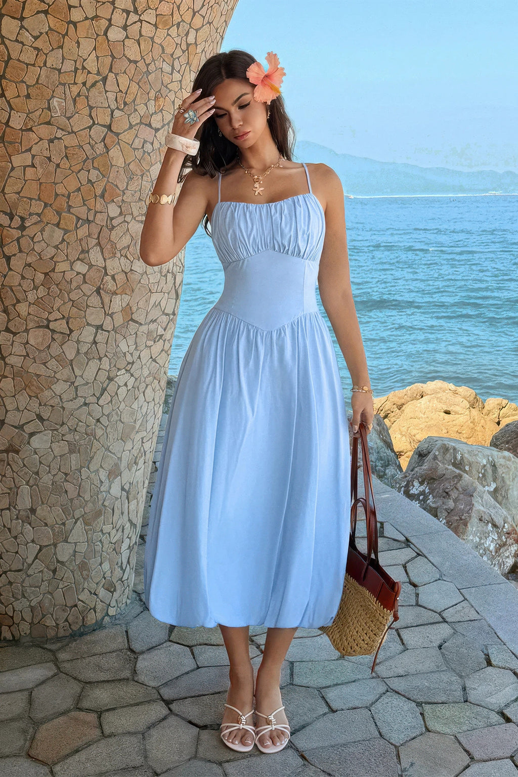 Blue ruched-bust A-line midi dress in a seaside setting