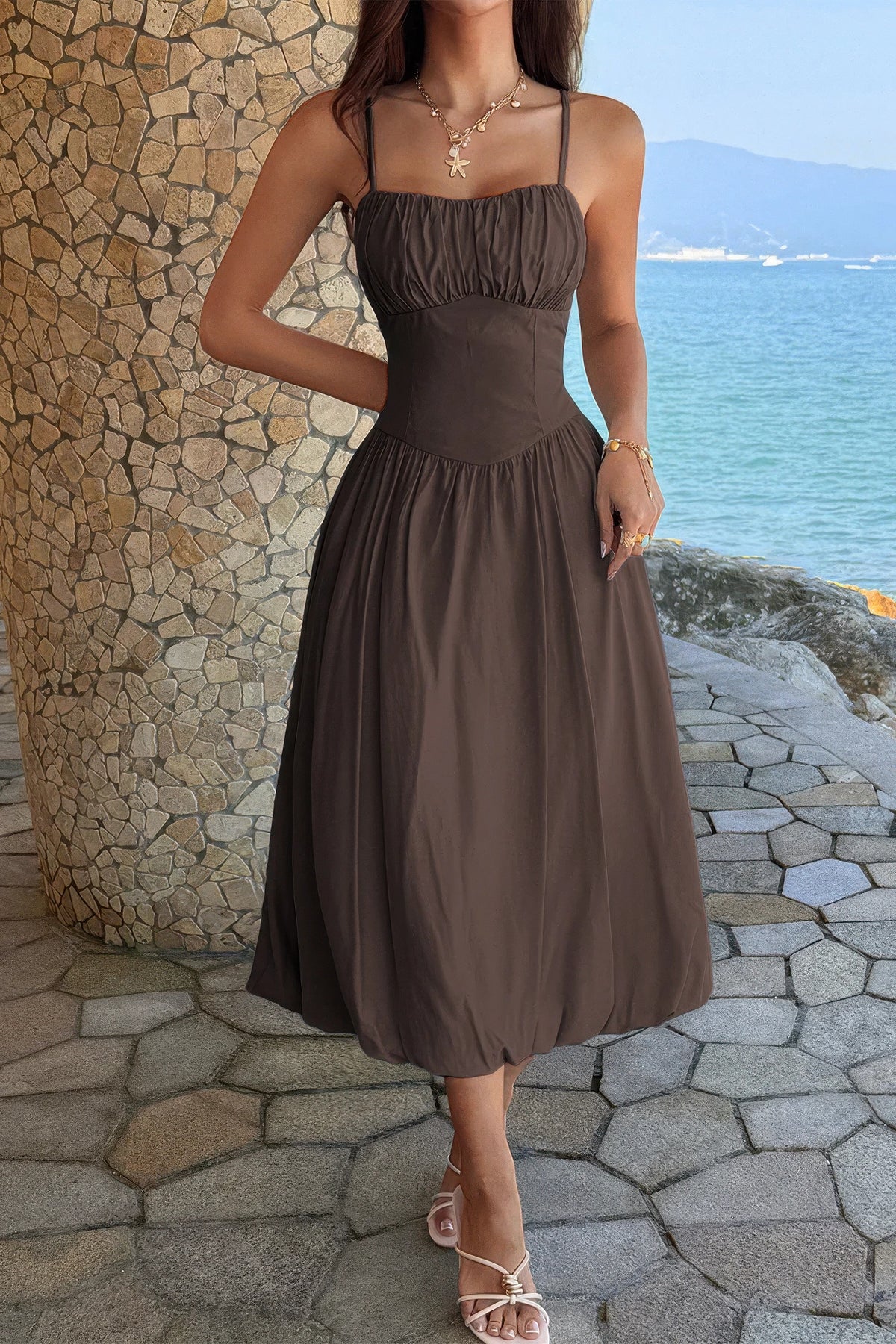Brown ruched-bust A-line midi dress showing the pointed basque waist