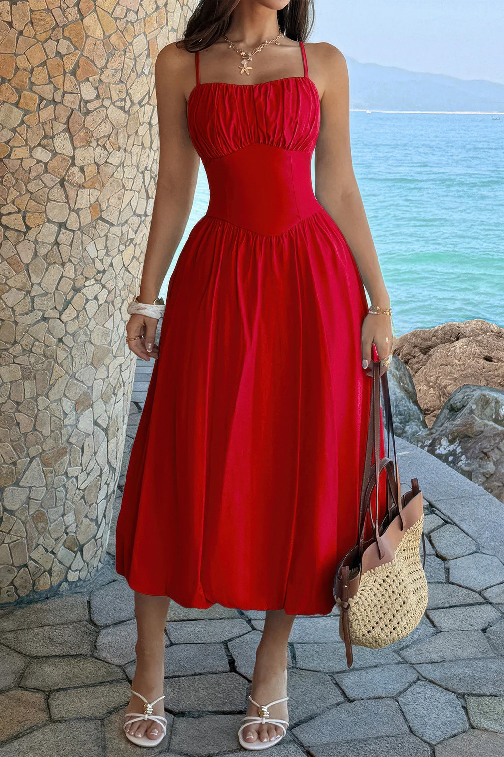 Red spaghetti-strap A-line dress showing the gathered bust and full midi skirt