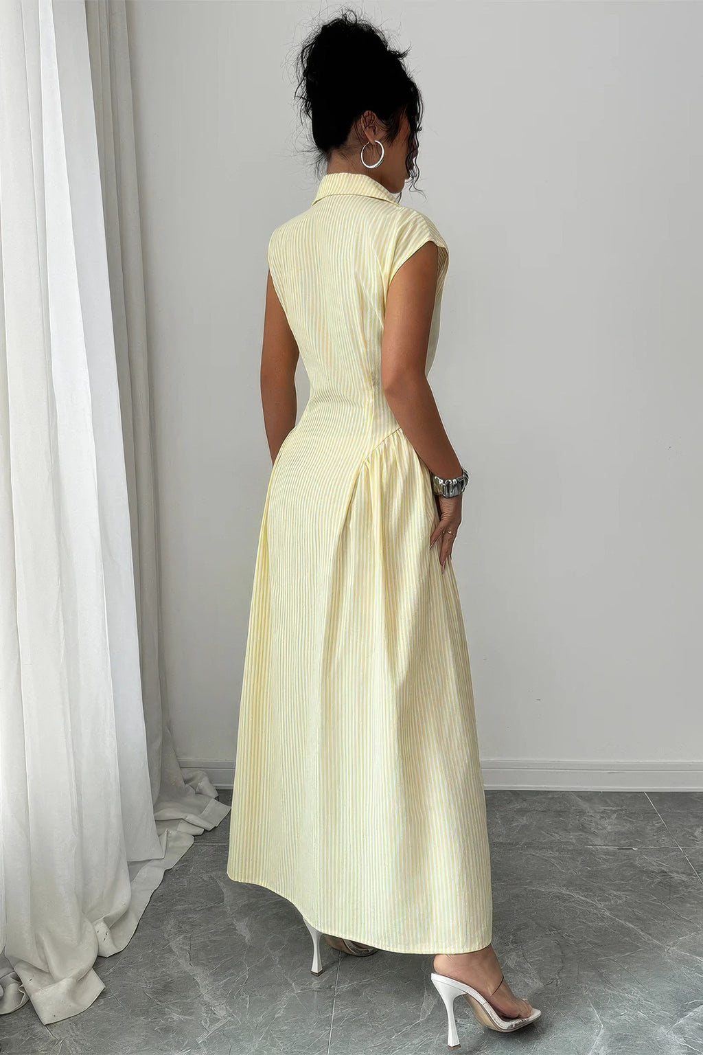 Back view of yellow pinstripe collared cap-sleeve gathered-waist long dress