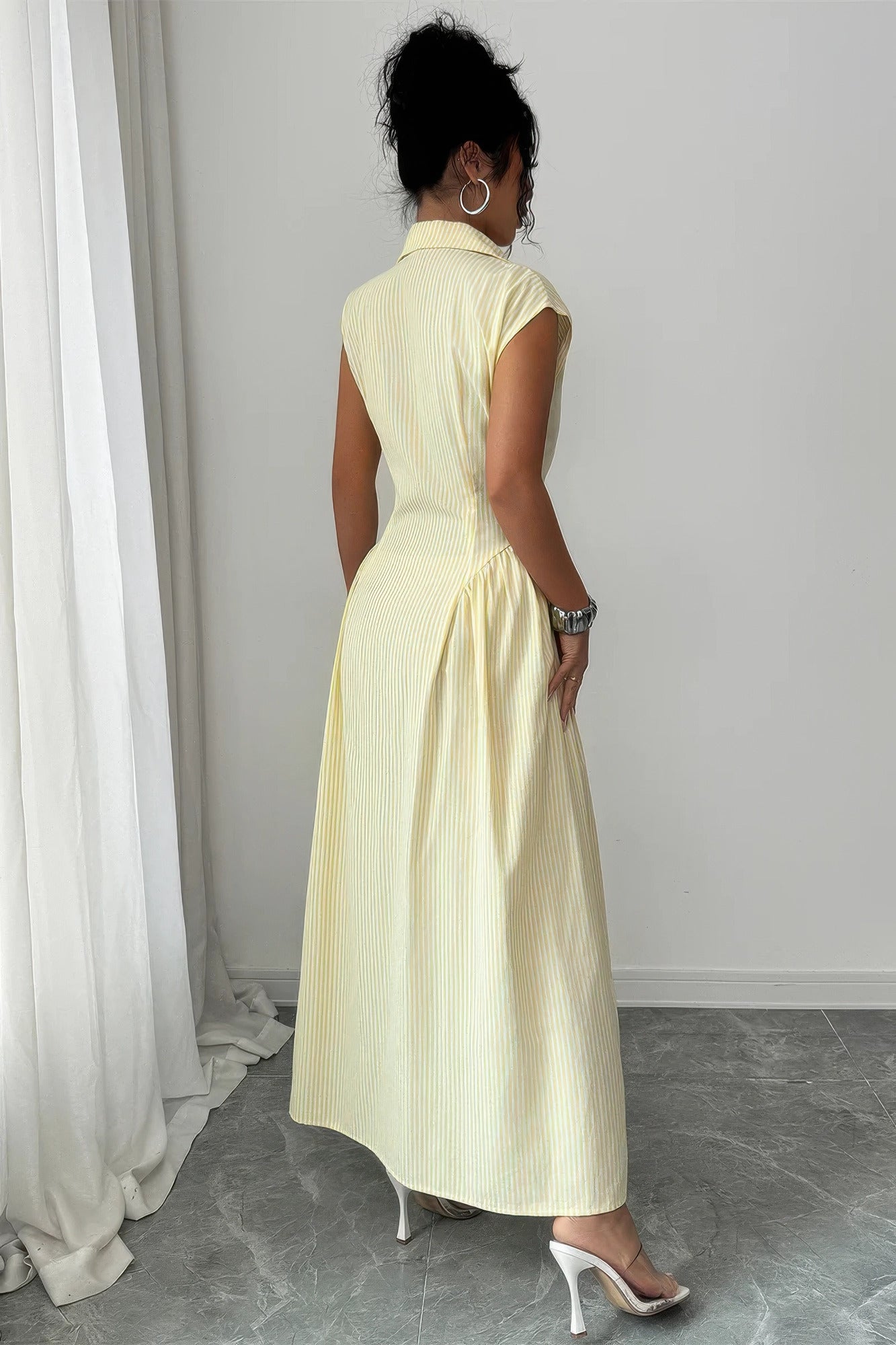 Back view of yellow pinstripe collared cap-sleeve gathered-waist long dress