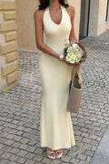 Model wearing the yellow Sunlit Command halter maxi dress, full front view