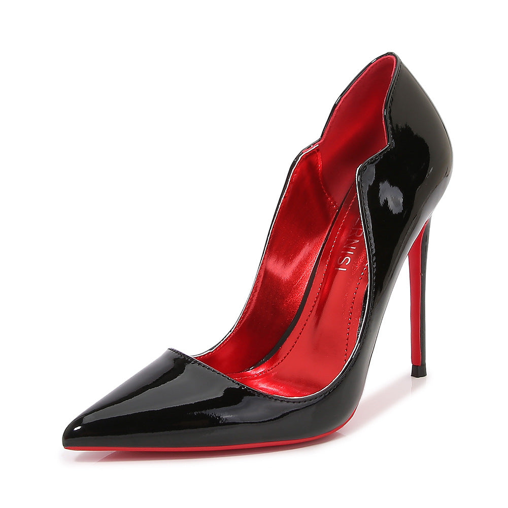 Black glossy Scarlet Sole Authority Pump in three-quarter view with pointed toe, sculpted wavy topline and scarlet-colored sole
