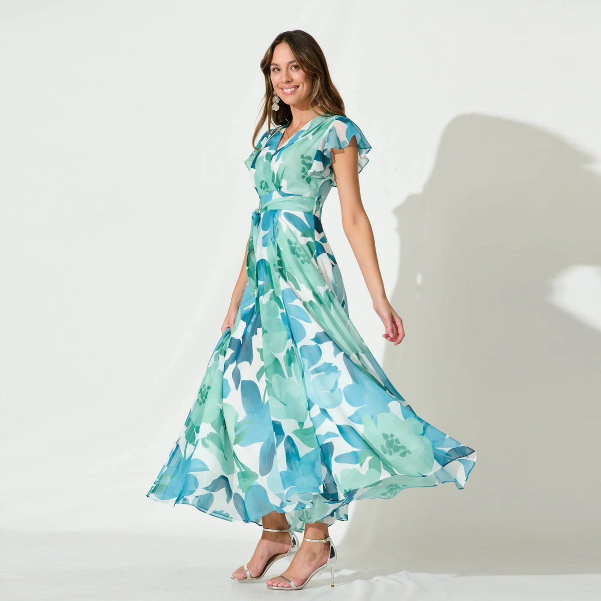 Petal Waltz light blue botanical tie-waist maxi dress, front movement view