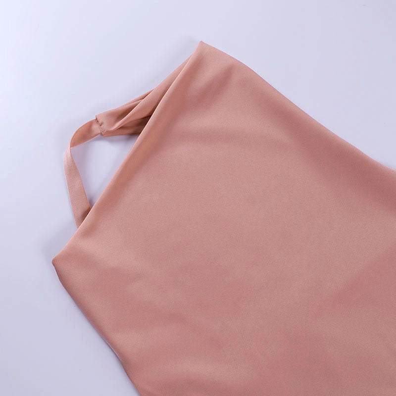 Close-up of the Champagne Hour pink satin fabric and halter strap