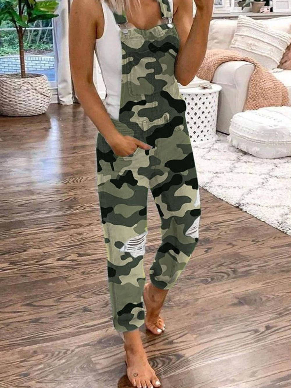 Model wearing camouflage Weekend Authority overalls with distressed knees, full-length front view