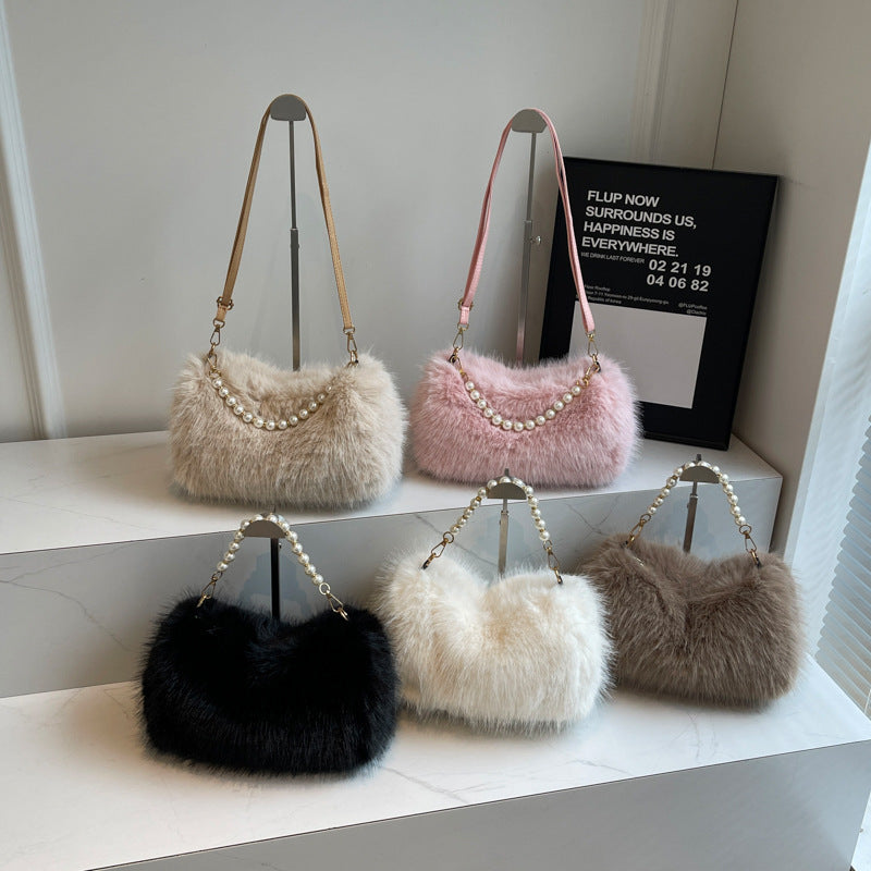 Black, beige, pink, white, and brown plush shoulder bags arranged together in a product display.