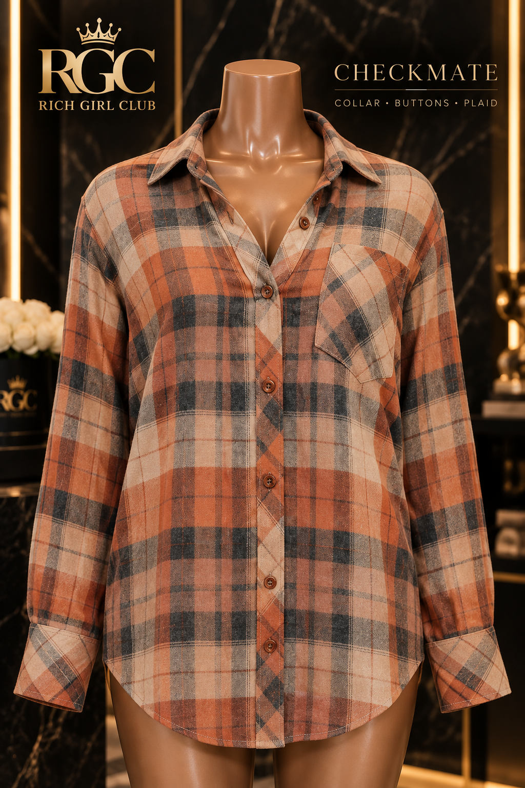 Close-up of the Checkmate rust plaid button-up shirt showing pointed collar, brown buttons, left chest pocket, long sleeves, and button cuffs.