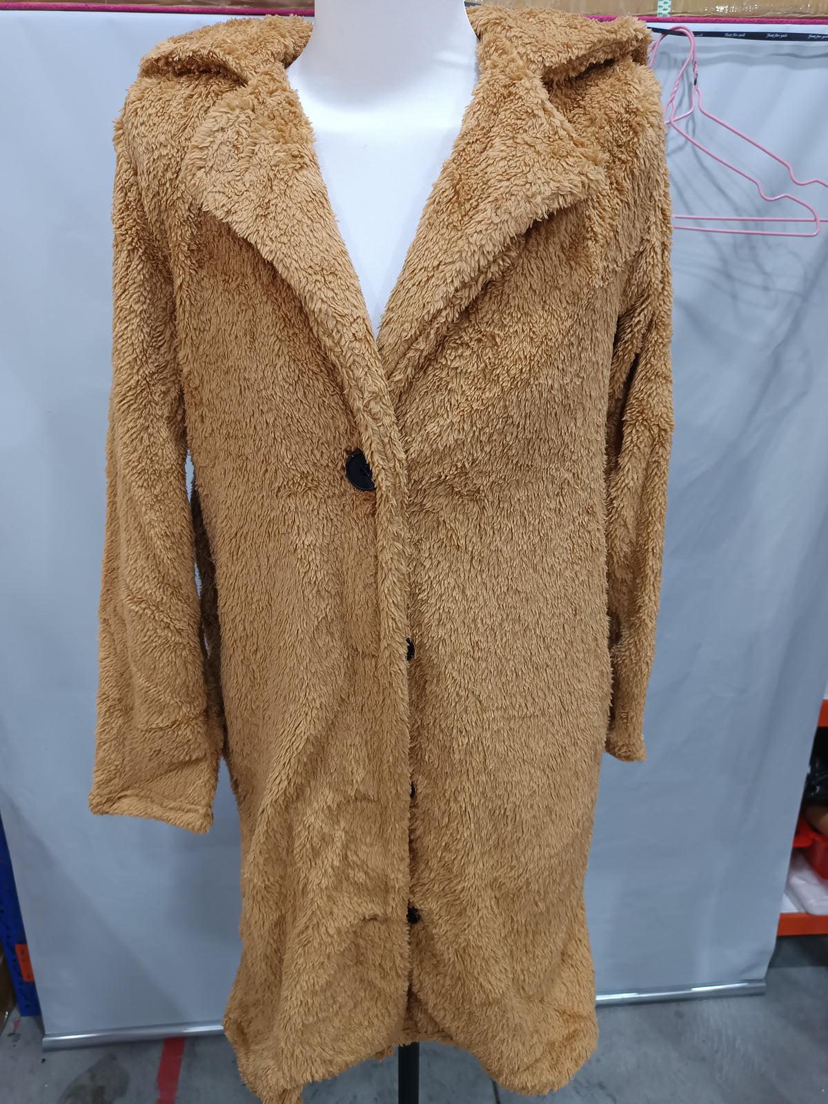 Camel plush longline jacket on a mannequin, close front view showing the lapel construction.
