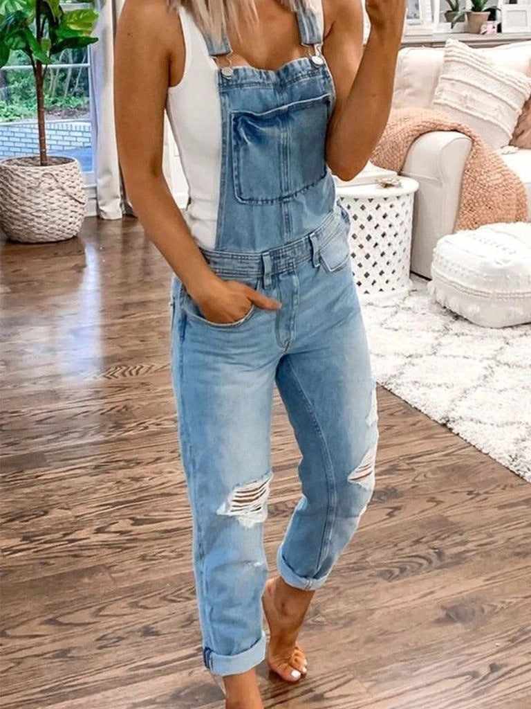Model wearing light blue Weekend Authority denim overalls with distressed knees and rolled cuffs