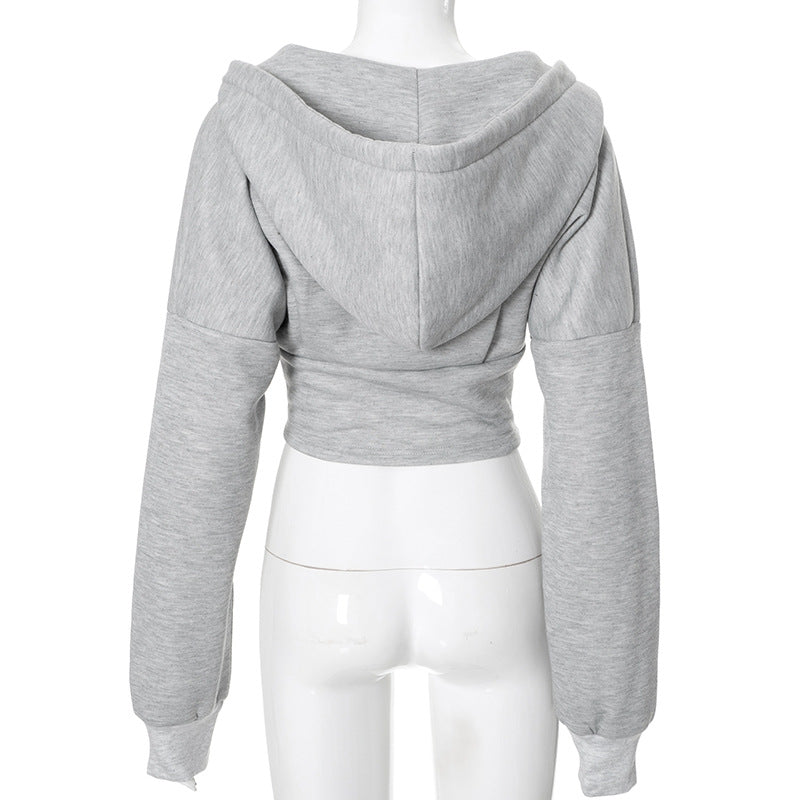 Grey corset-style zip hoodie on a mannequin, rear view showing the hood and cropped hem.