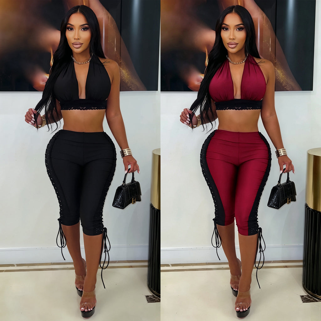 Models wearing After Hours halter crop-top and lace-up capri-pants set in black and wine red, front view