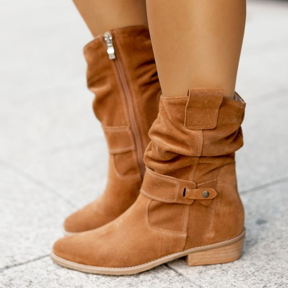 Brown Saddle Sway Suede Boots worn in a close-up view showing the slouch shaft and side zipper.